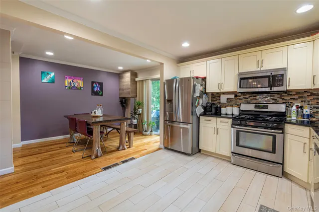 a kitchen with stainless steel appliances a refrigerator stove microwave and sink