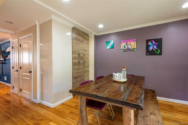 a view of a dining room with furniture a chandelier and wooden floor