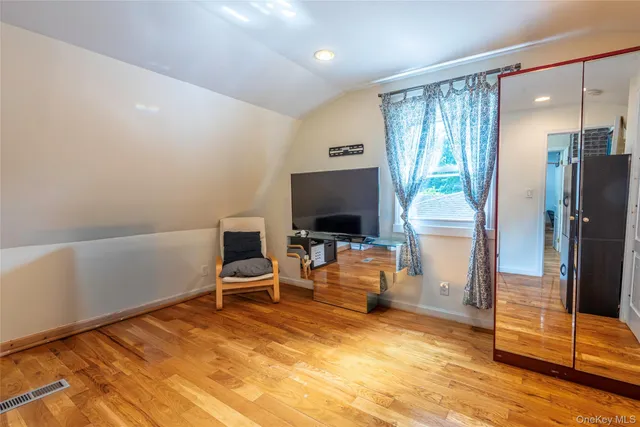 a view of a livingroom with furniture and a flat screen tv