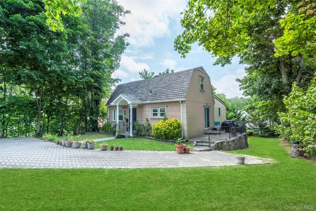 a front view of house with yard and green space