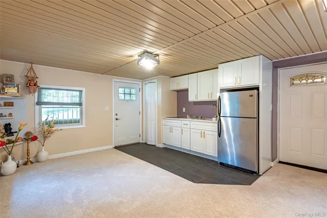 a kitchen with refrigerator and window