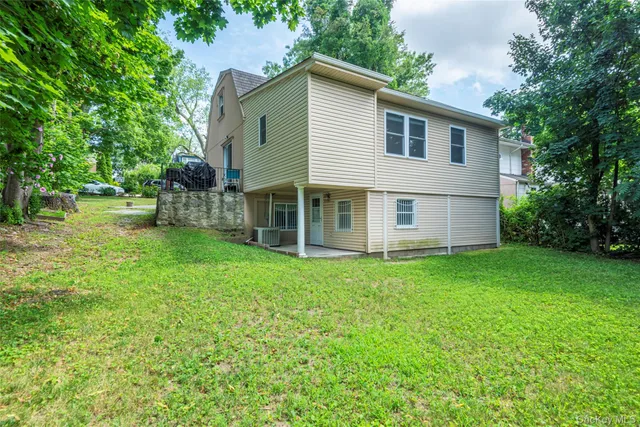 a view of a house with a backyard