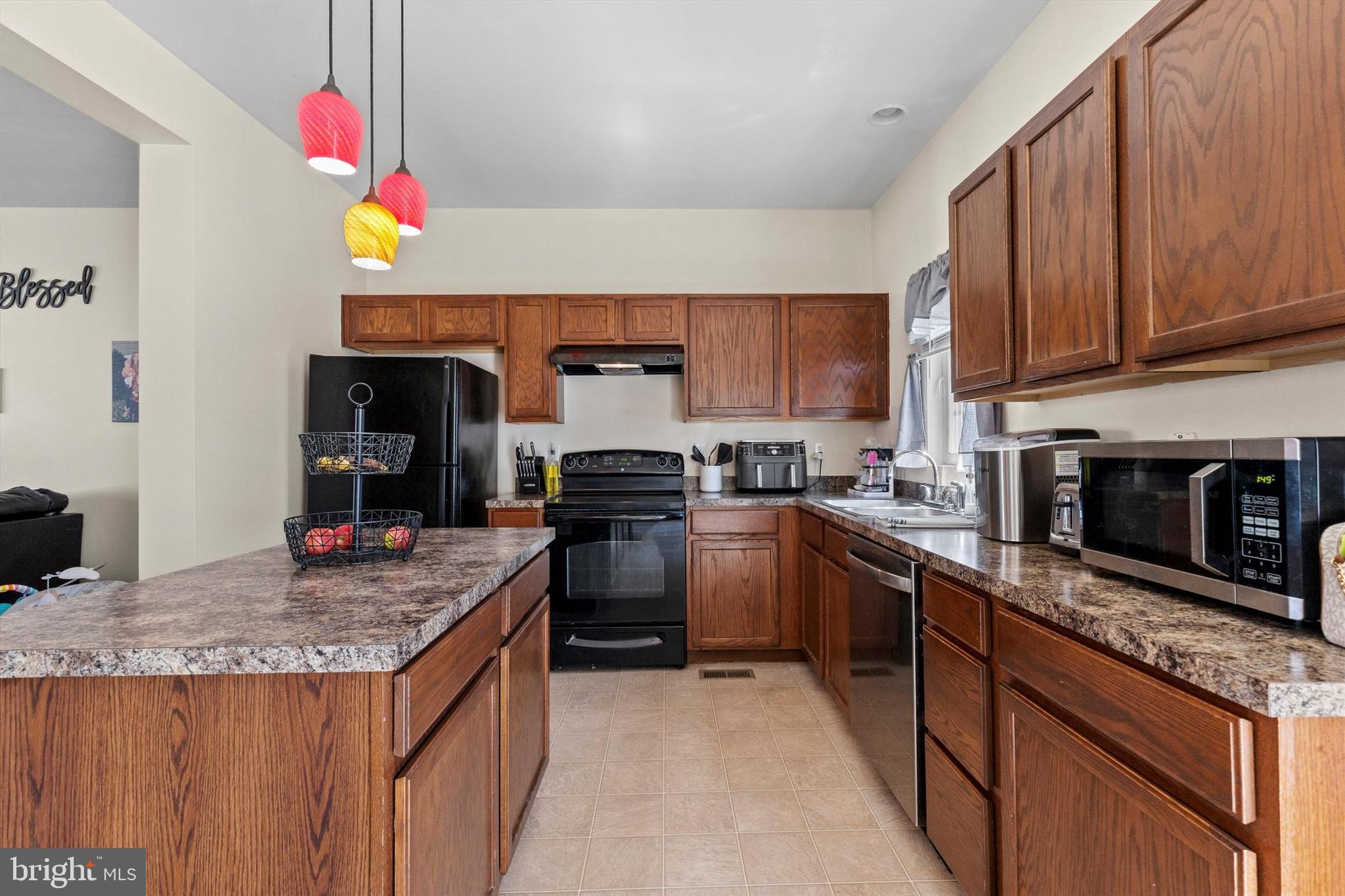 4113 Trabert Court Dover, PA 17315 - Photo 12 of 28 a kitchen with granite countertop kitchen island stainless steel appliances a stove sink microwave and cabinets