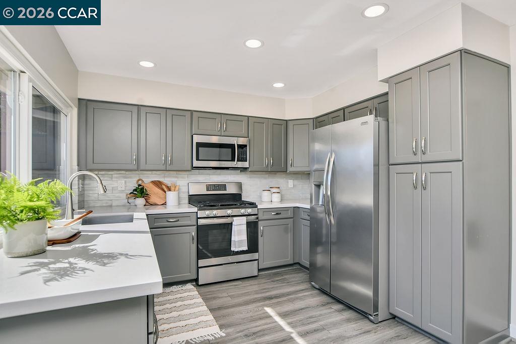 508 Viewmont Street Benicia, CA 94510 - Photo 11 of 34 a kitchen with stainless steel appliances granite countertop a refrigerator a stove and a sink
