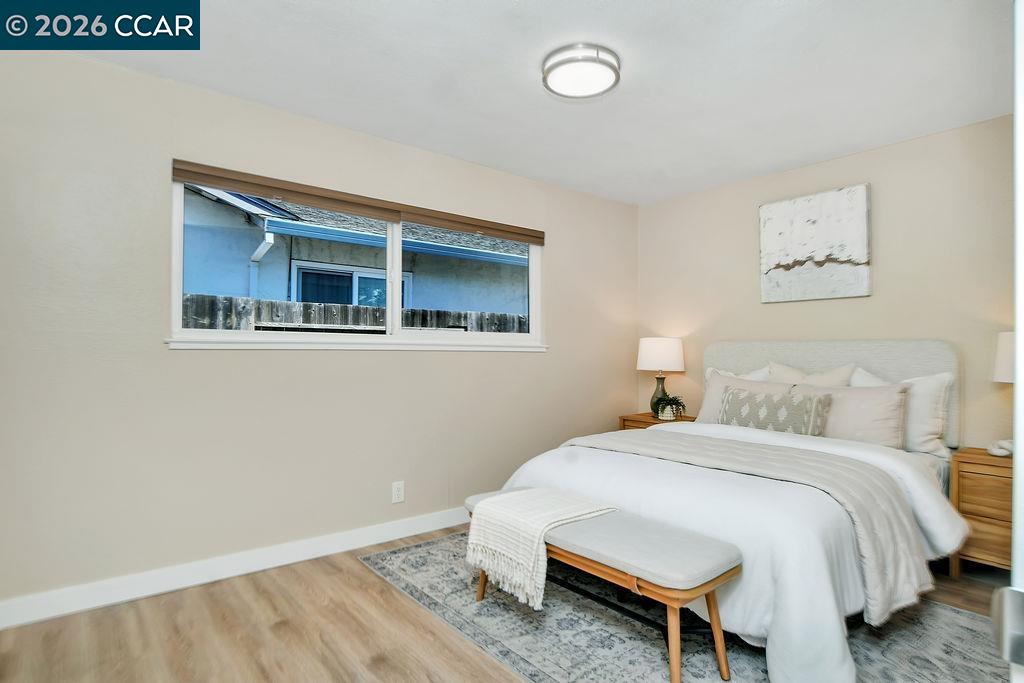 508 Viewmont Street Benicia, CA 94510 - Photo 13 of 34 a bedroom with a bed and a wall painting