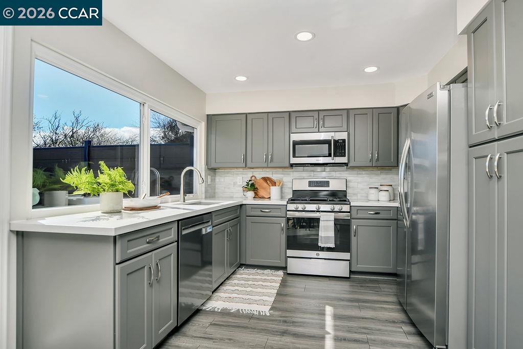 508 Viewmont Street Benicia, CA 94510 - Photo 10 of 34 a kitchen with stainless steel appliances granite countertop a sink and stove top oven