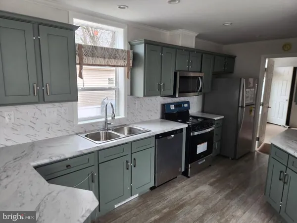 a kitchen with a sink stove and refrigerator