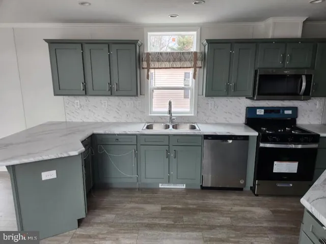 a kitchen with granite countertop a sink and a stove top oven