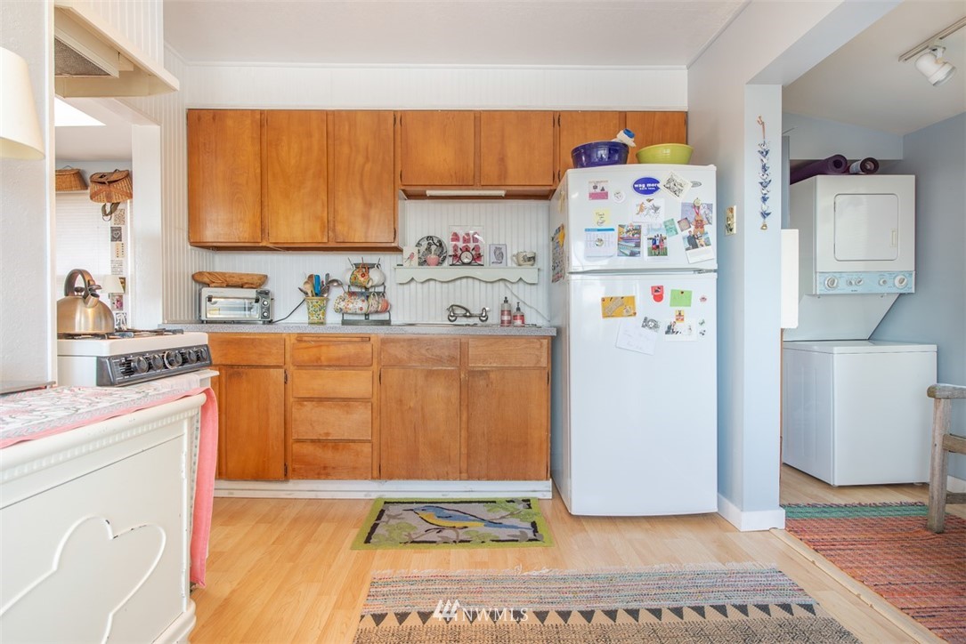 424 North 68th Street Seattle, WA 98103 - Photo 14 of 26 a utility room with a refrigerator and washer