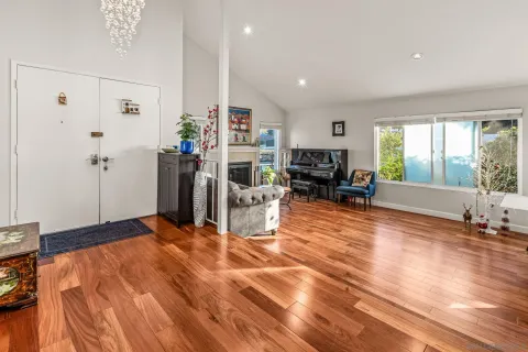 a living room with furniture and large windows