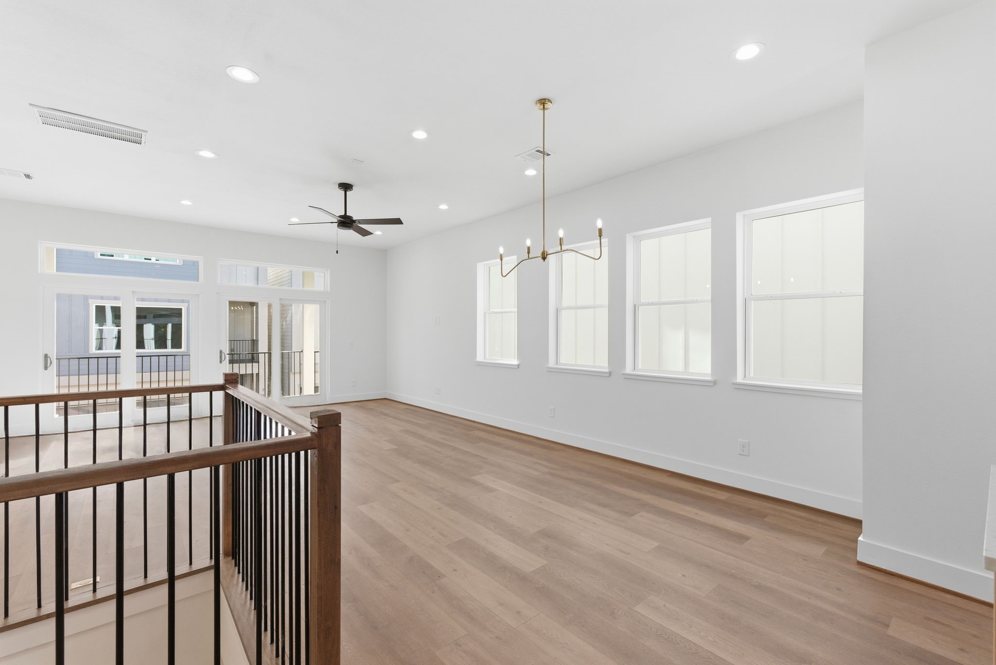 7706 Earl Rudder Way Houston, TX 77055 - Photo 14 of 46 a view of an empty room with wooden floor and a window