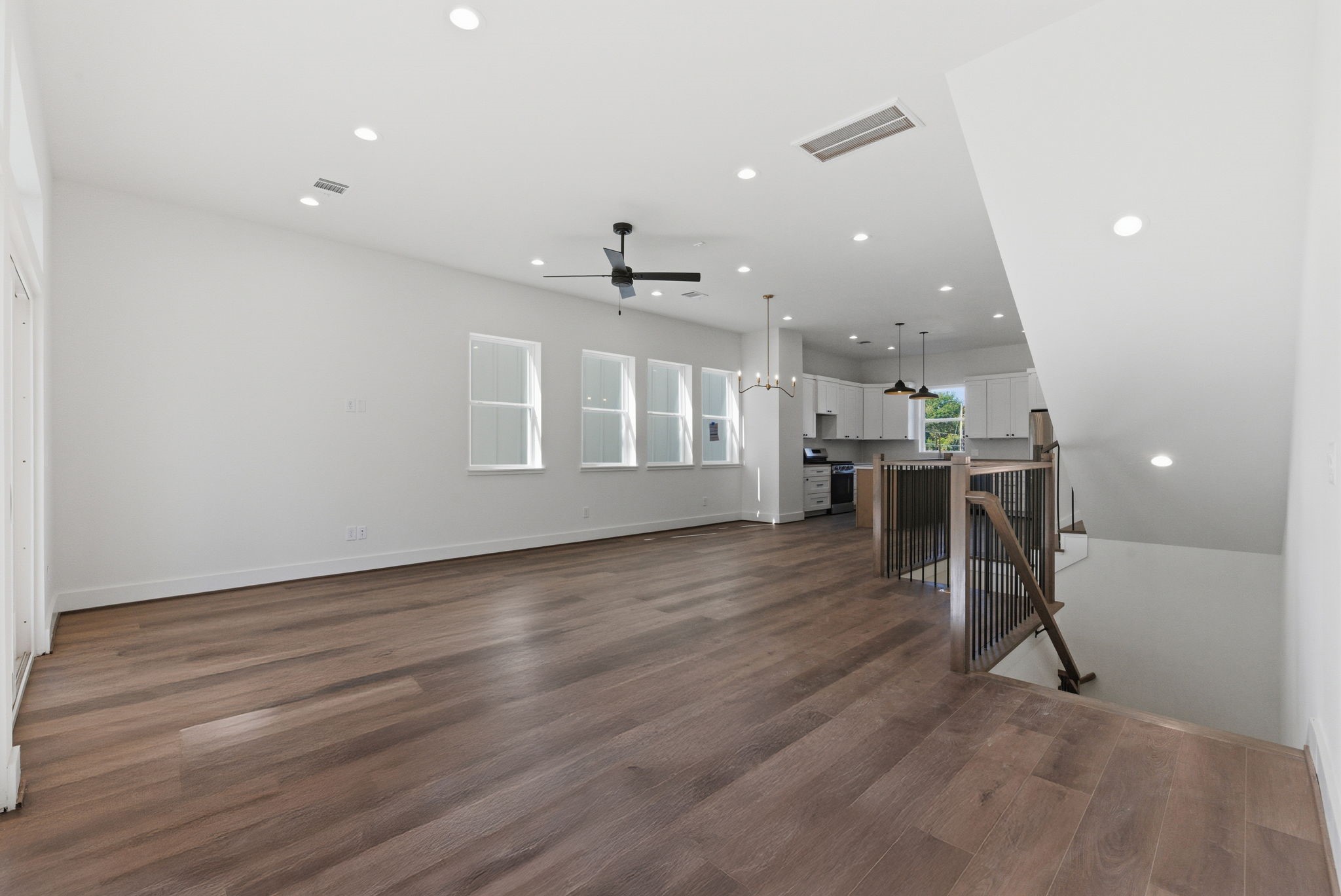 7706 Earl Rudder Way Houston, TX 77055 - Photo 17 of 46 an empty room with wooden floor and windows