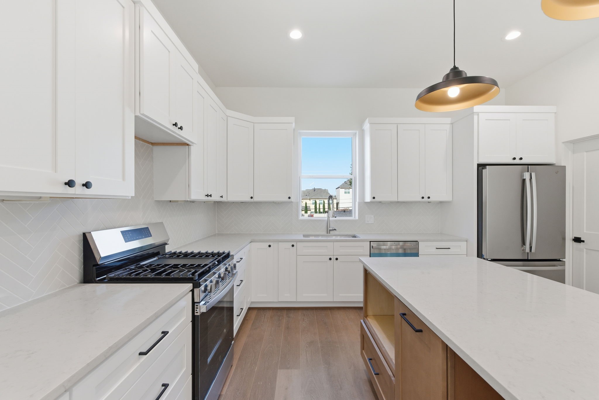 7706 Earl Rudder Way Houston, TX 77055 - Photo 22 of 46 a kitchen with stainless steel appliances a stove a sink a refrigerator and cabinets