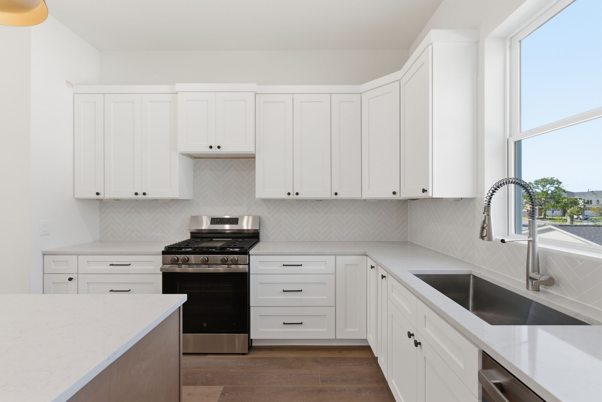 7706 Earl Rudder Way Houston, TX 77055 - Photo 23 of 46 a kitchen with granite countertop white cabinets and stainless steel appliances