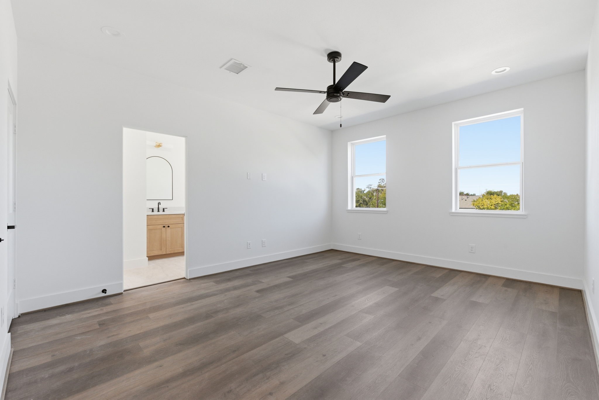 7706 Earl Rudder Way Houston, TX 77055 - Photo 29 of 46 wooden floor in an empty room with a window