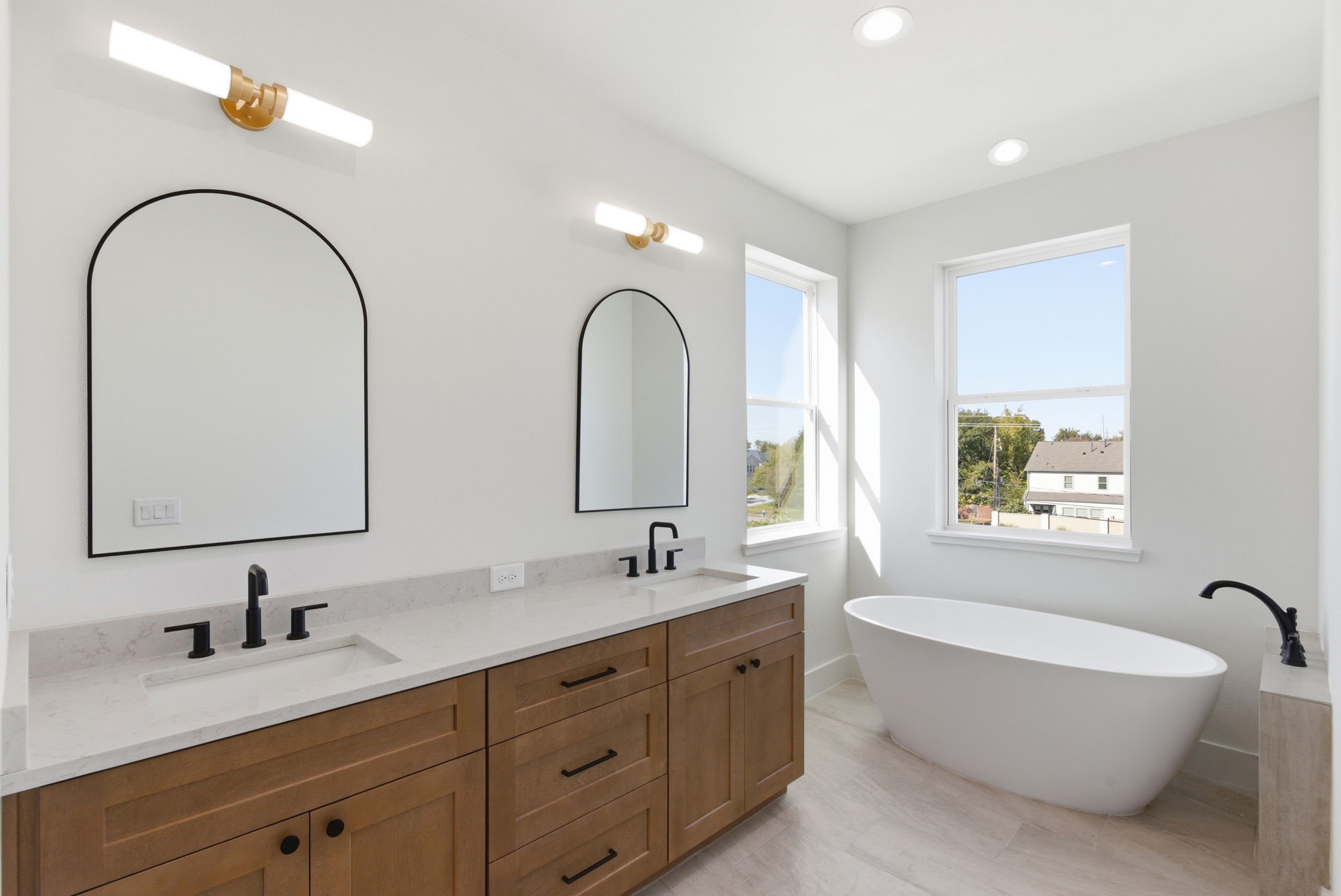 7706 Earl Rudder Way Houston, TX 77055 - Photo 31 of 46 a spacious bathroom with a double vanity sink mirror and a bathtub
