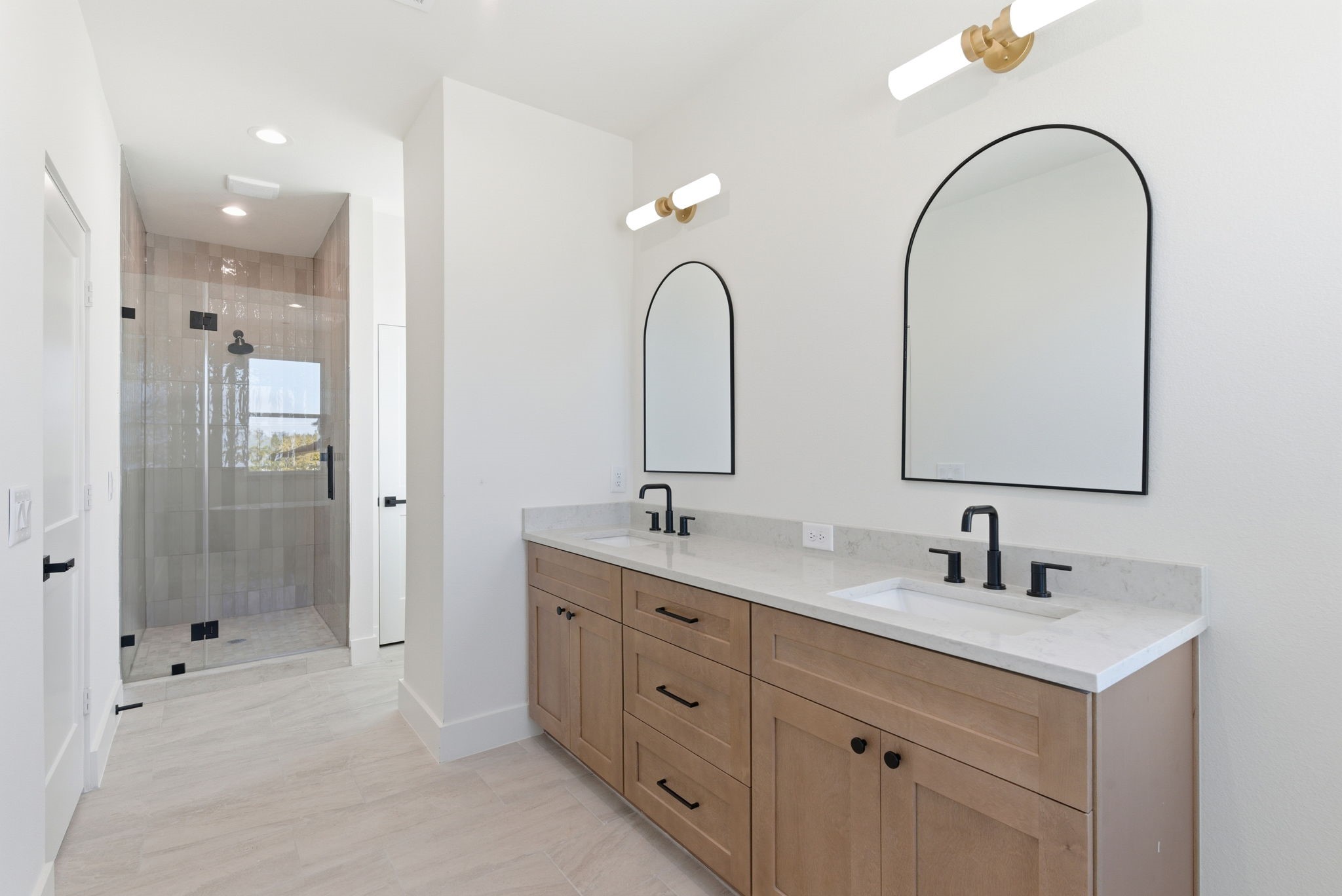7706 Earl Rudder Way Houston, TX 77055 - Photo 32 of 46 a bathroom with a double vanity sink mirror and shower