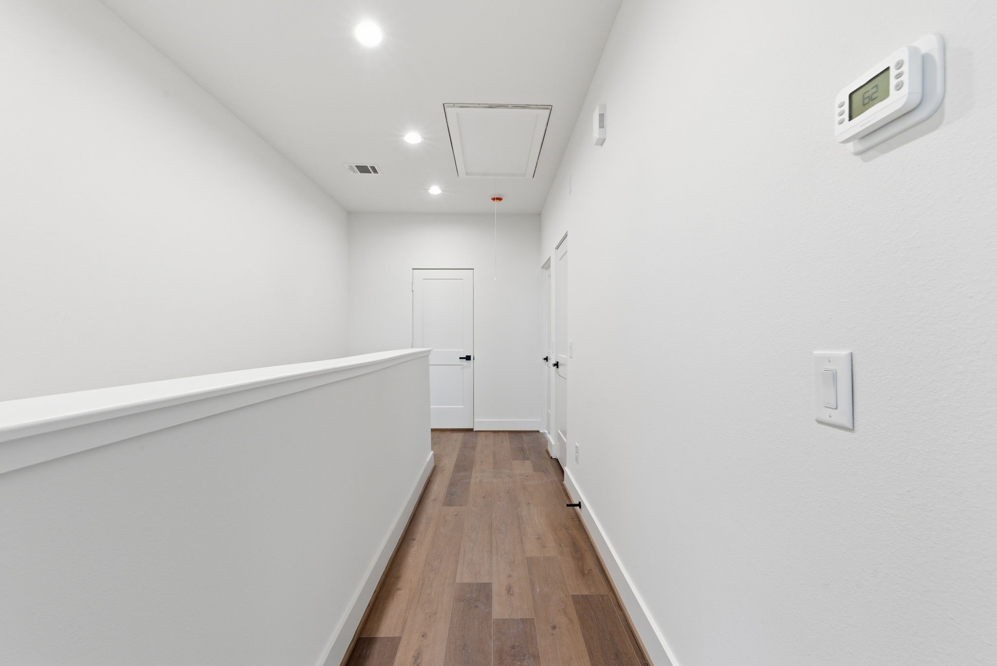 7706 Earl Rudder Way Houston, TX 77055 - Photo 35 of 46 a view of a hallway with wooden floor