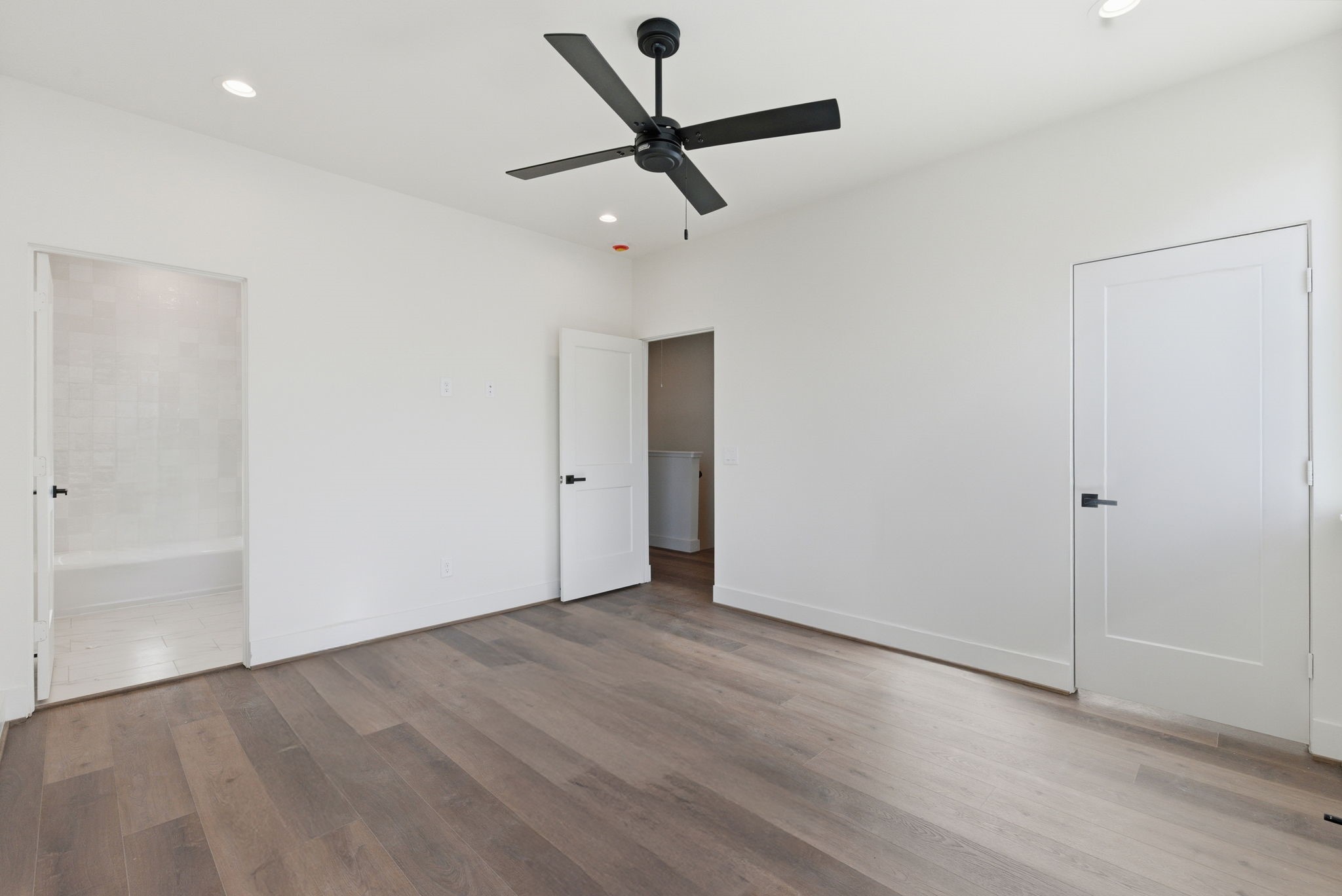 7706 Earl Rudder Way Houston, TX 77055 - Photo 37 of 46 an empty room to ceiling fan and wooden floor