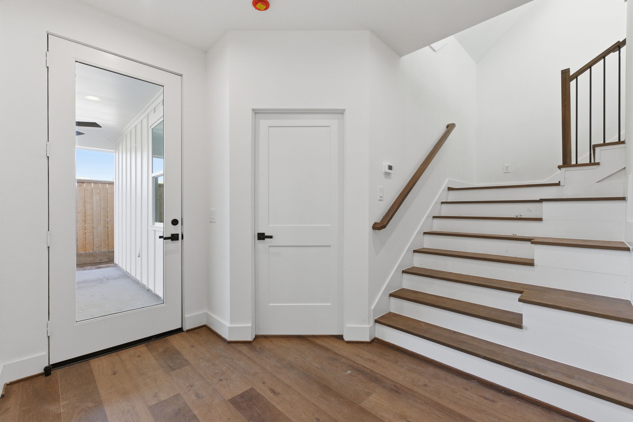 7706 Earl Rudder Way Houston, TX 77055 - Photo 7 of 46 a view of entryway with wooden floor and stairs