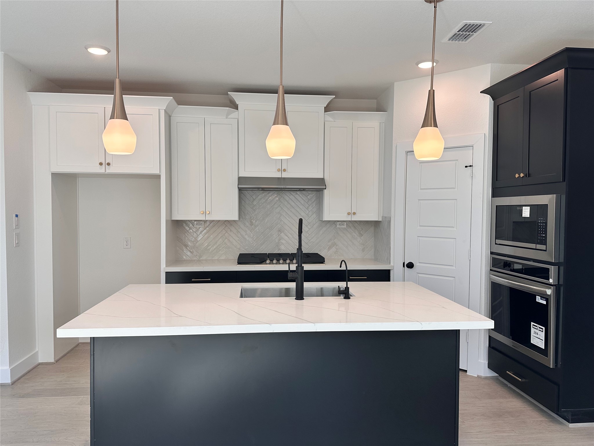 5115 Getty Lane Iowa Colony, TX 77578 - Photo 3 of 29 a kitchen with a sink a counter space appliances and cabinets