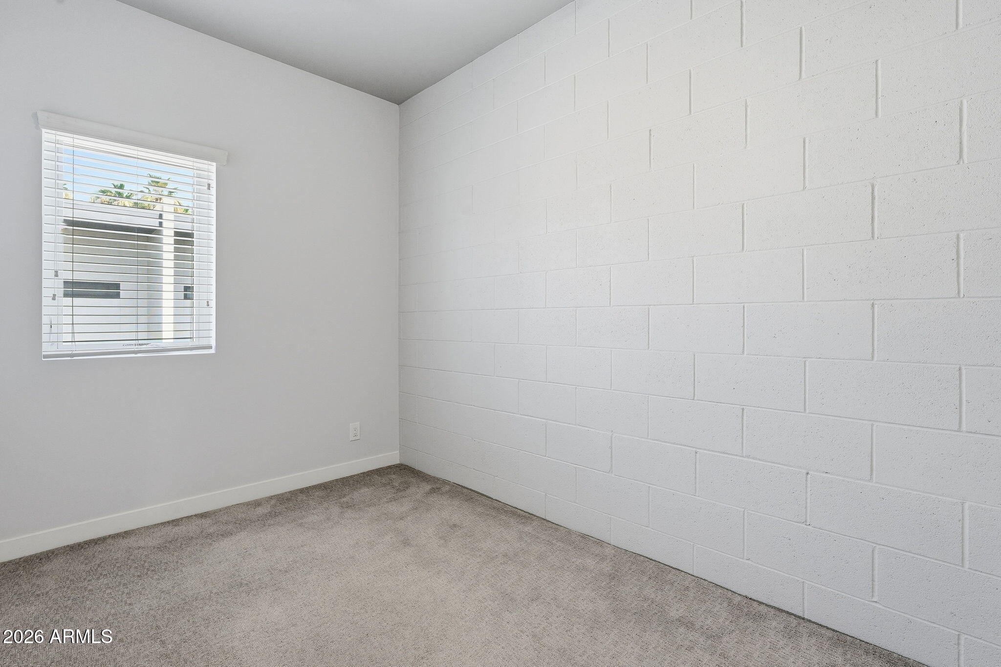 2727 East Thomas Road, Unit 5 Phoenix, AZ 85016 - Photo 20 of 41 a view of an empty room with a window