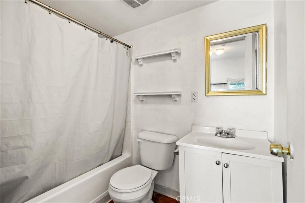 1602 Davis Street Chico, CA 95928 - Photo 15 of 24 a white toilet sitting next to a bathroom sink