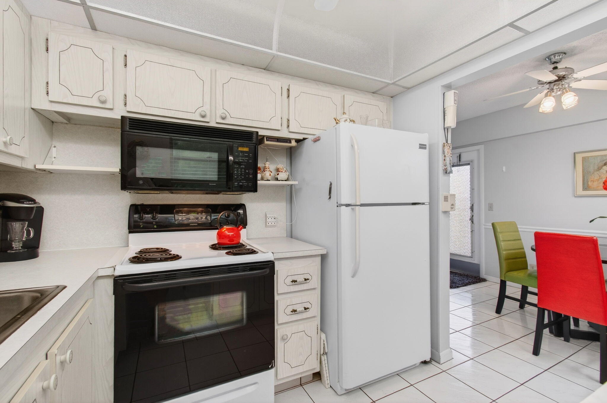 281 Dorset G Boca Raton, FL 33434 - Photo 16 of 85 a kitchen with stainless steel appliances a stove a microwave and a refrigerator