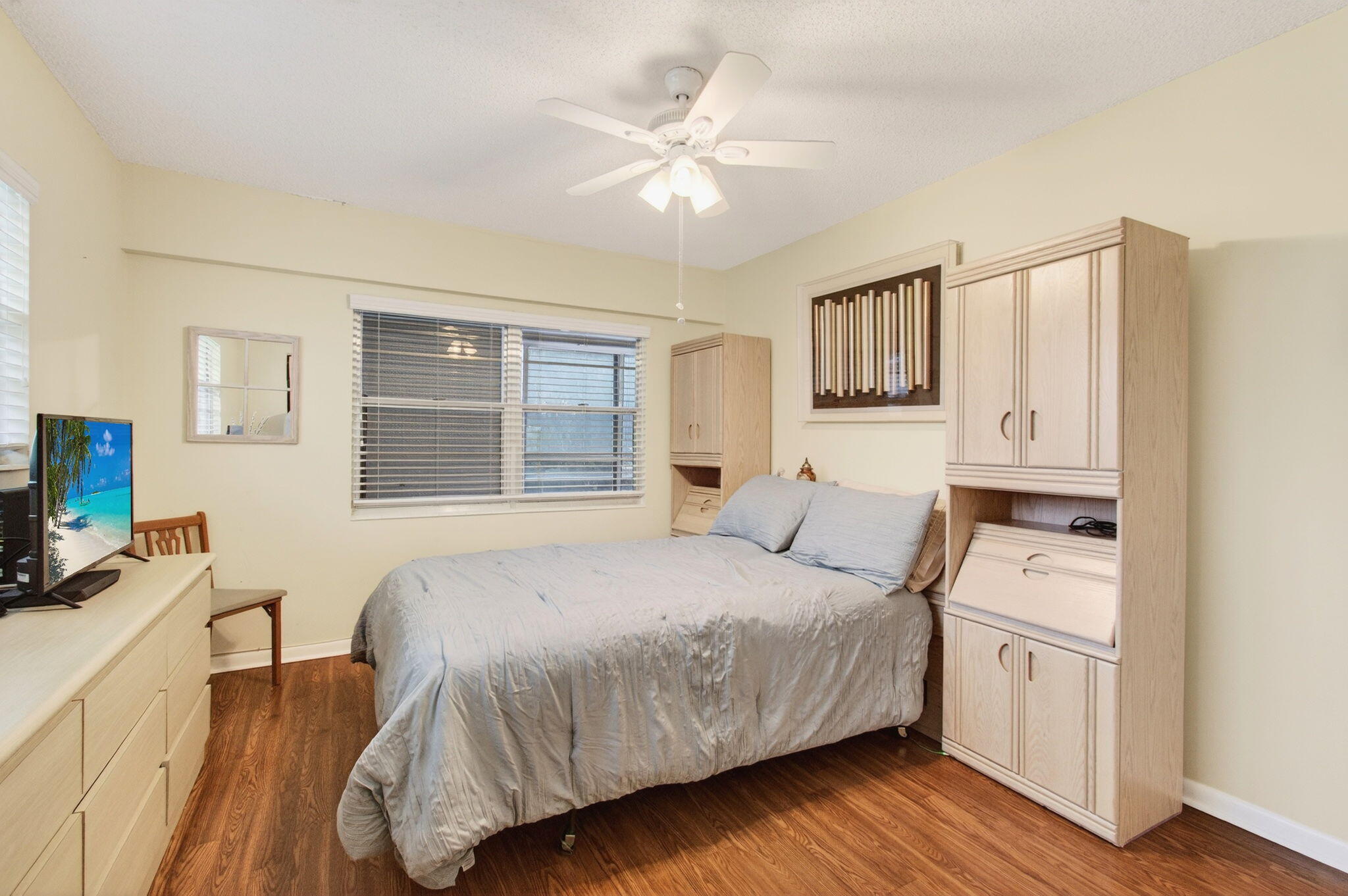 281 Dorset G Boca Raton, FL 33434 - Photo 21 of 85 a bedroom with a large bed a flat tv screen and dresser