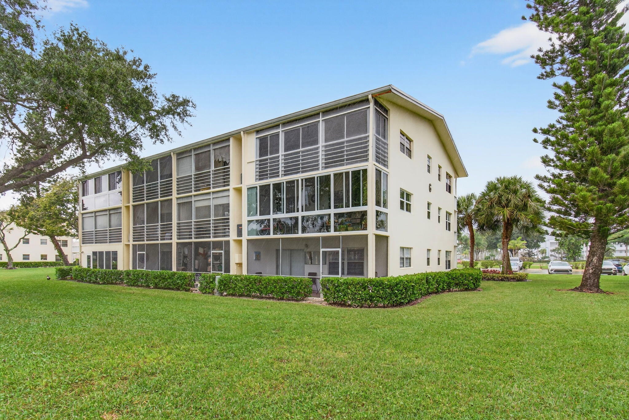 281 Dorset G Boca Raton, FL 33434 - Photo 41 of 85 a front view of a building with a garden