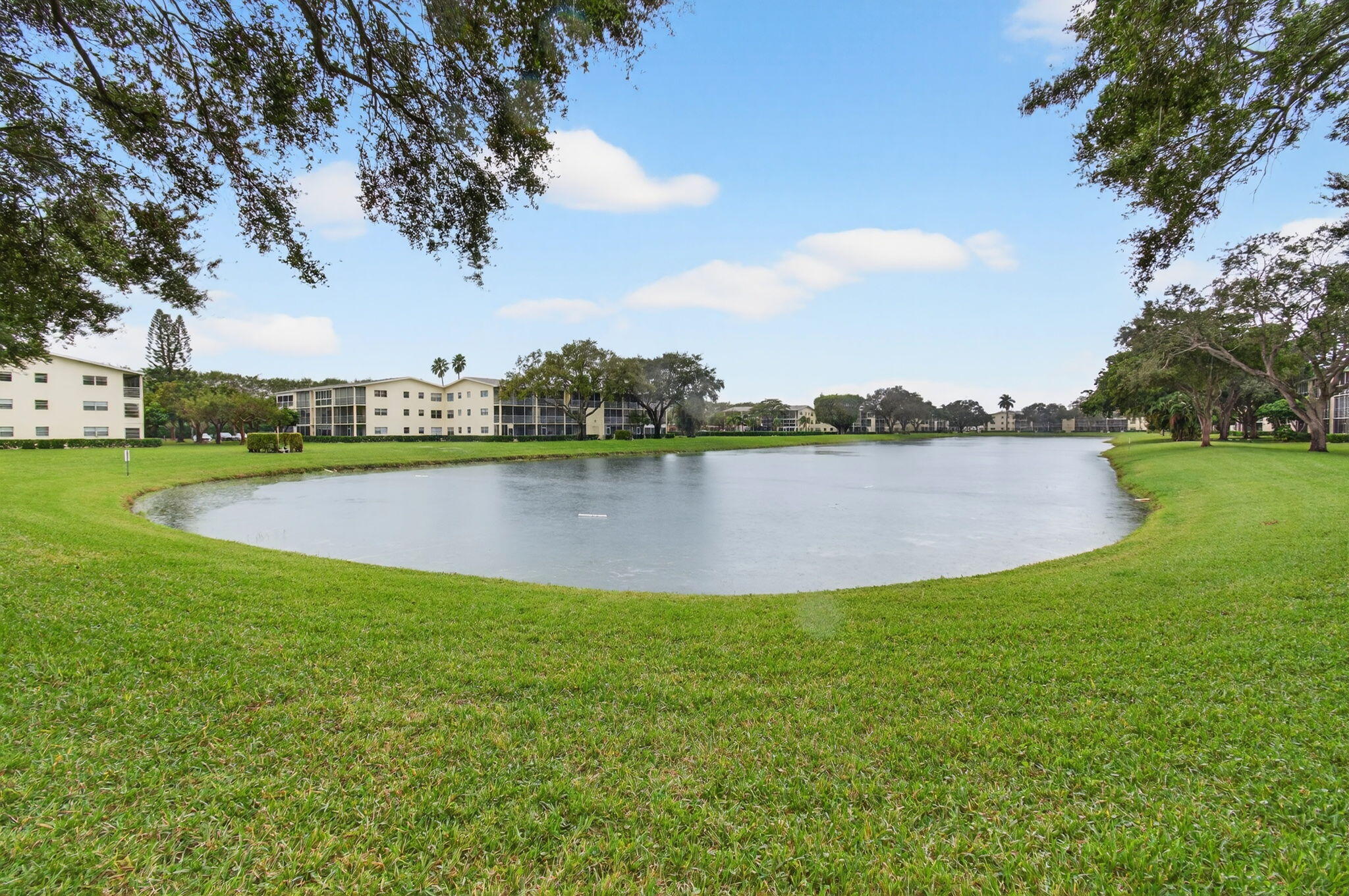 281 Dorset G Boca Raton, FL 33434 - Photo 43 of 85 a view of a lake with houses in the back