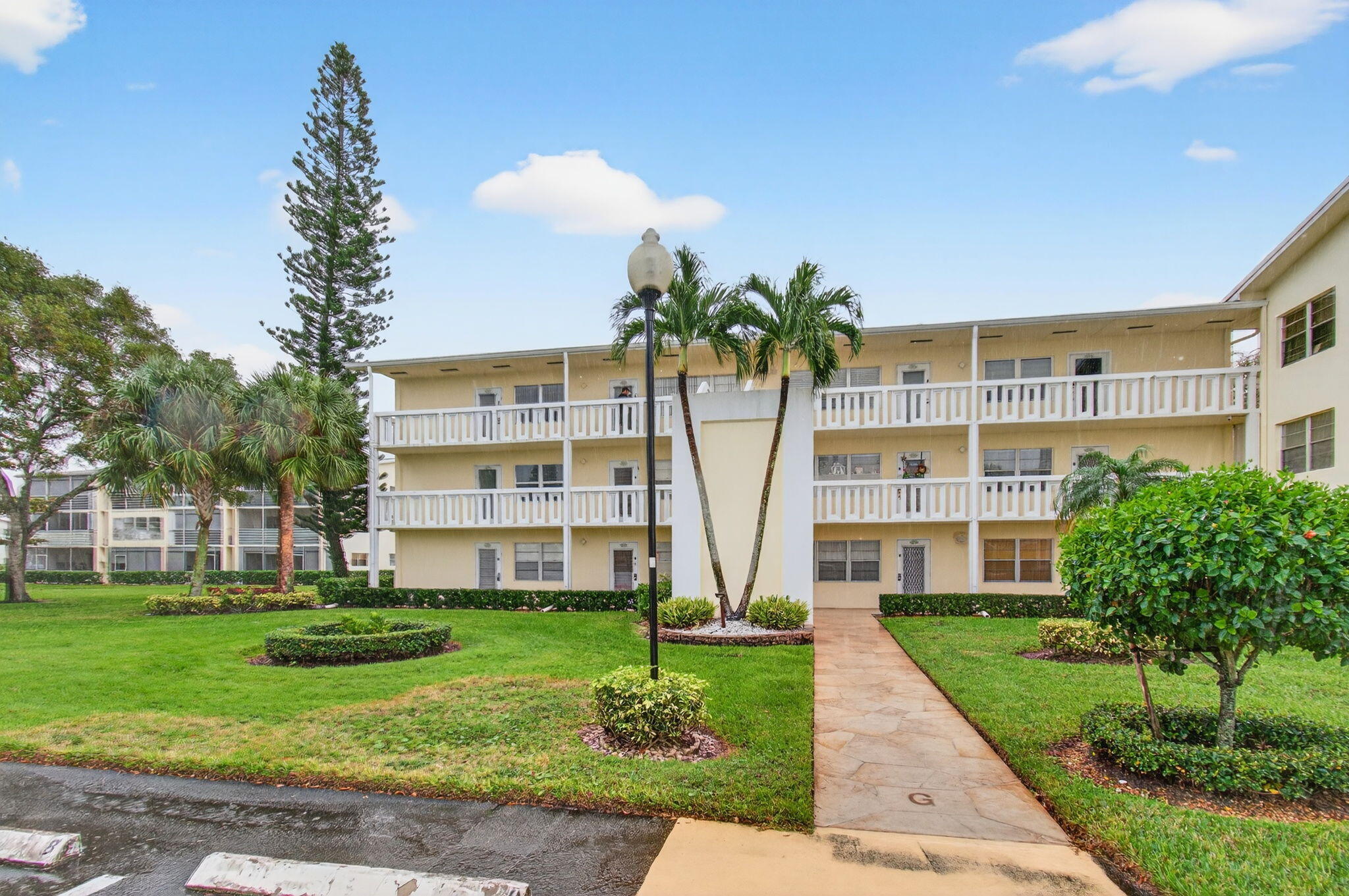 281 Dorset G Boca Raton, FL 33434 - Photo 44 of 85 a front view of a building with garden