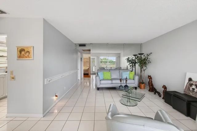 a living room with furniture and a potted plant