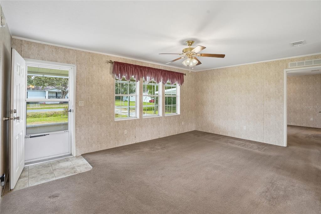 11305 Broadview Road Seffner, FL 33584 - Photo 11 of 34 an empty room with windows and ceiling fan