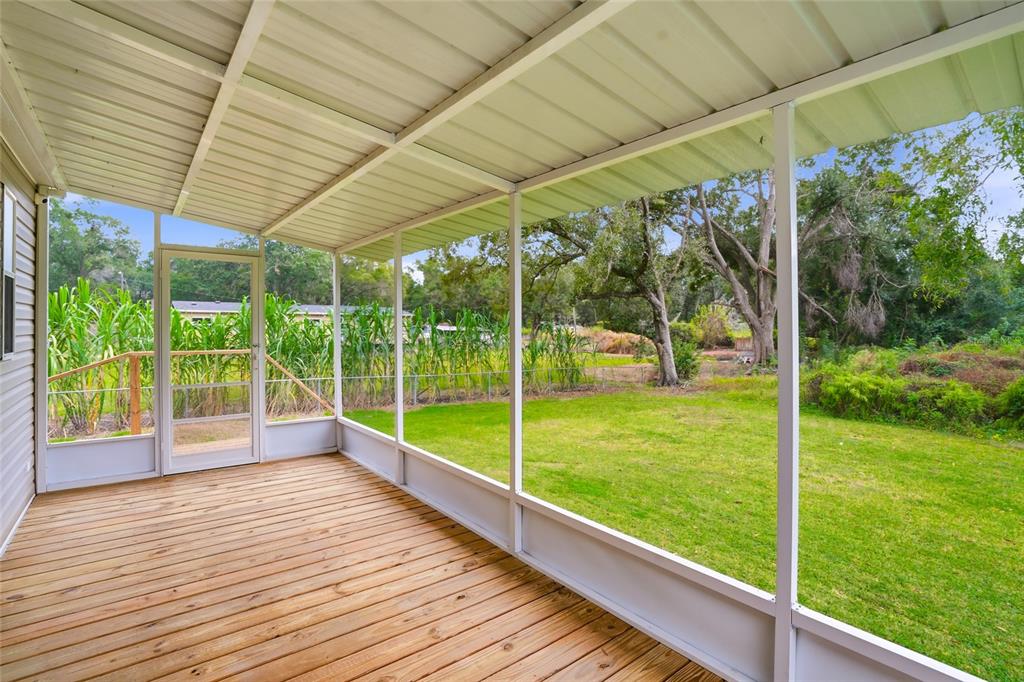 11305 Broadview Road Seffner, FL 33584 - Photo 25 of 34 a view of a deck with a big yard