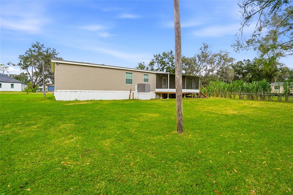 11305 Broadview Road Seffner, FL 33584 - Photo 28 of 34 a view of a house with a yard and a large tree