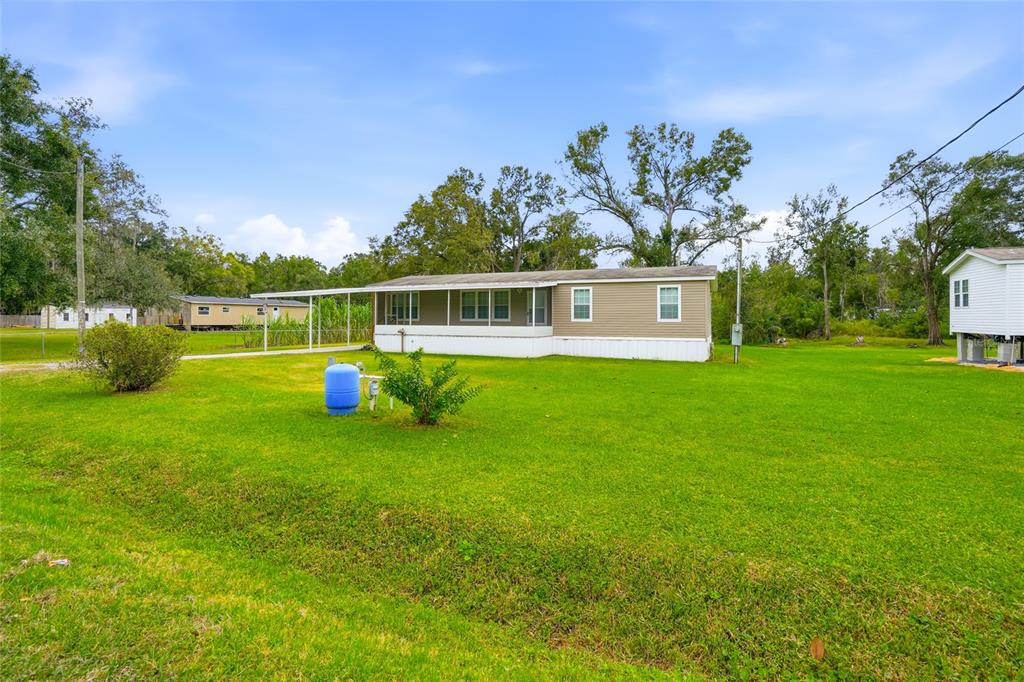 11305 Broadview Road Seffner, FL 33584 - Photo 5 of 34 a view of a house with a backyard