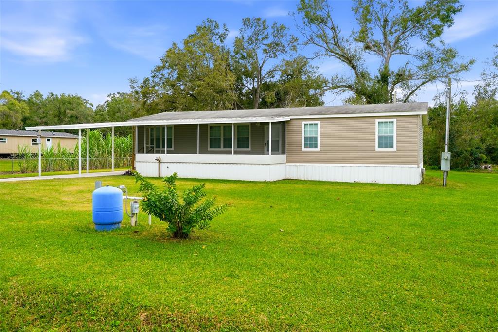 11305 Broadview Road Seffner, FL 33584 - Photo 6 of 34 a house view with a sitting space and garden