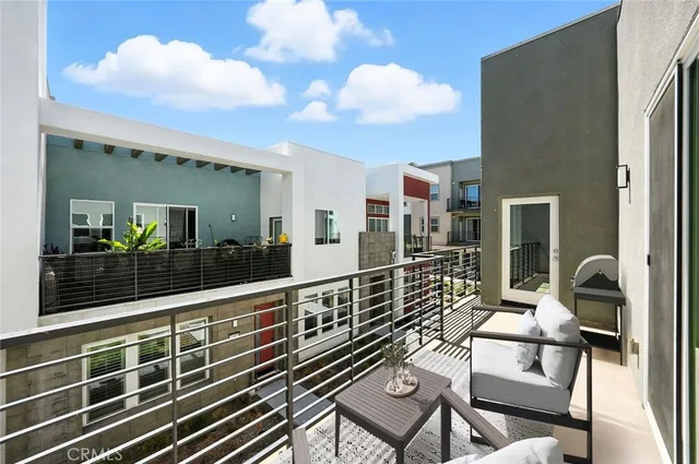 a view of a balcony with dining table and chairs with wooden floor