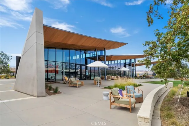a view of a patio with a table and chairs under an umbrella