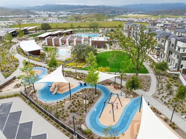 an aerial view of a residential houses with outdoor space