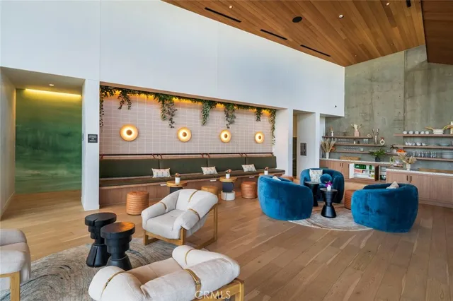 a living room with furniture and a floor to ceiling window