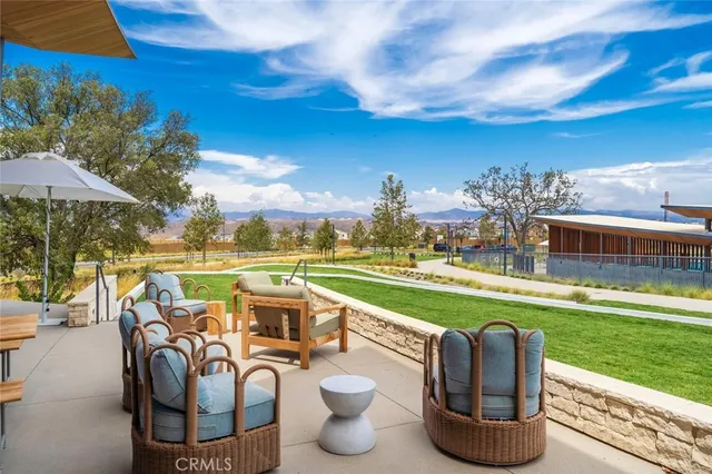 a view of a chairs and table in patio with a lake view