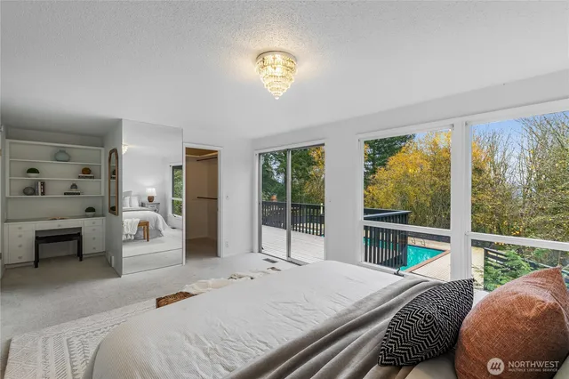 a bedroom with a bed and a large window