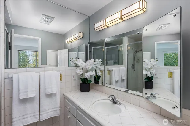 a bathroom with a tub sink and mirror