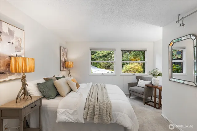 a bedroom with a bed and glass window