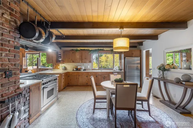 a kitchen with stainless steel appliances granite countertop a stove a sink and a refrigerator