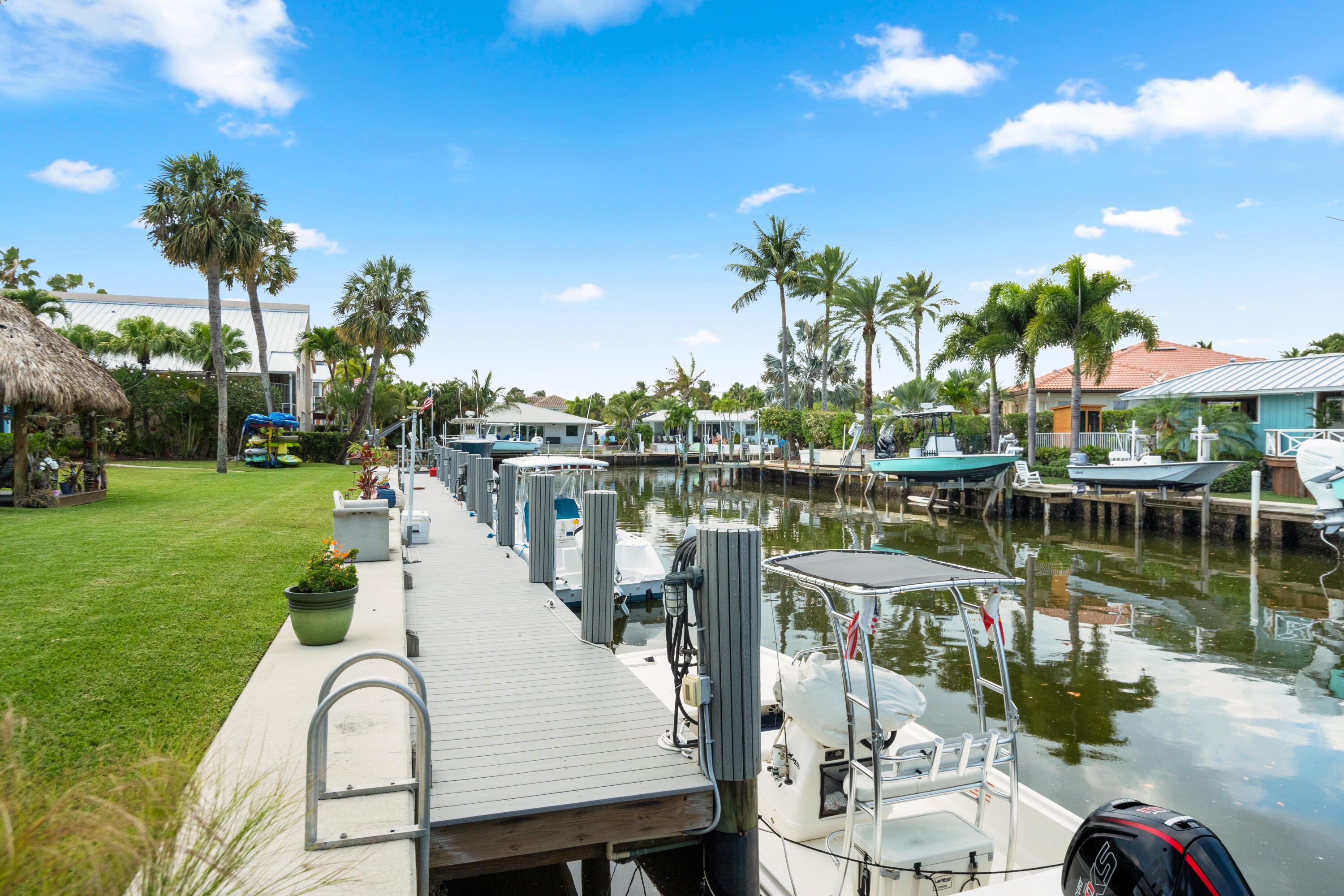 249 Center Street, Unit 2C Jupiter, FL 33458 - Photo 5 of 29 a view of a lake with boats and palm trees