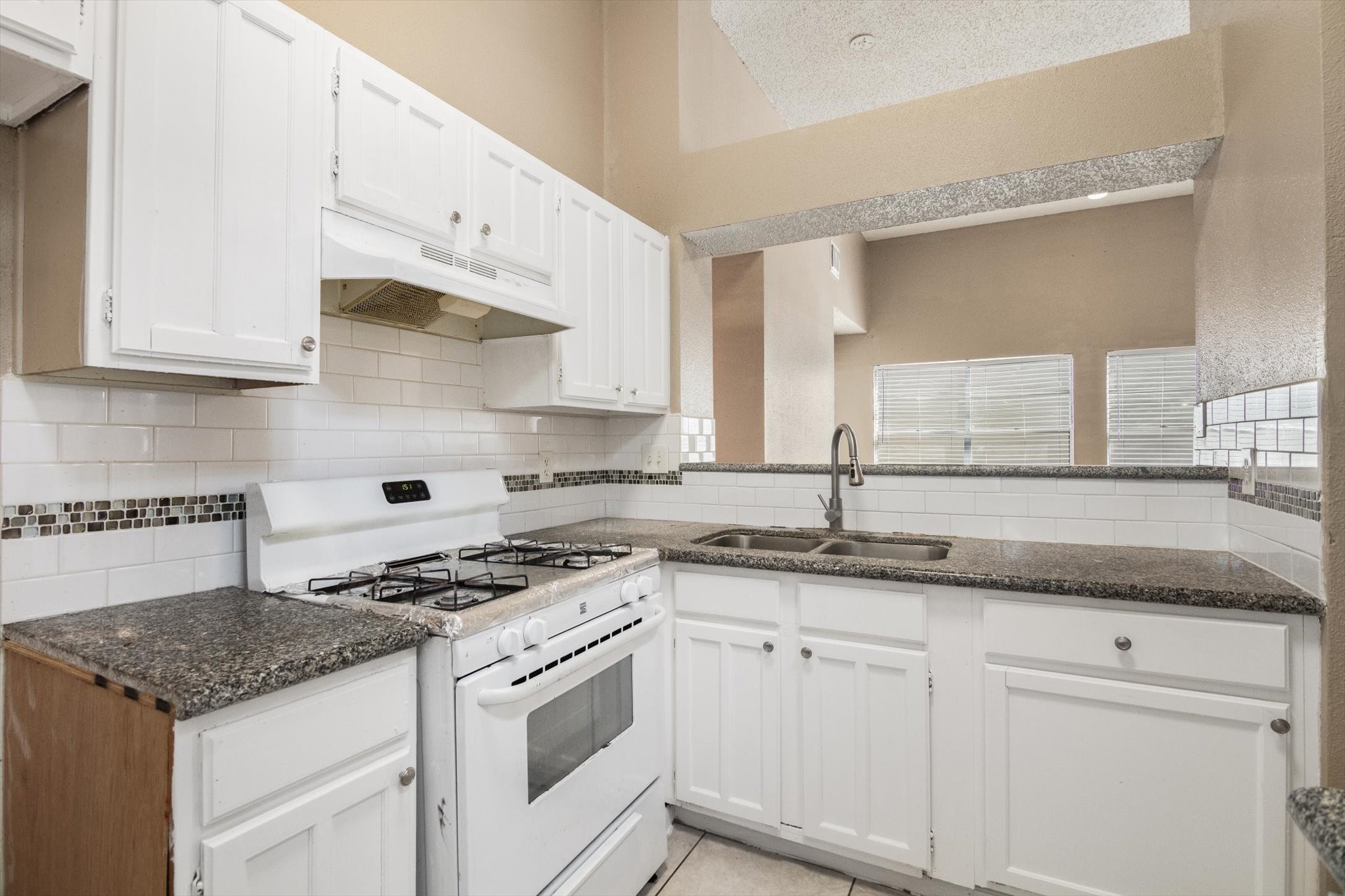 4403 Conward Drive Houston, TX 77066 - Photo 11 of 25 a kitchen with granite countertop stainless steel appliances white cabinets granite counter tops and a wooden floors