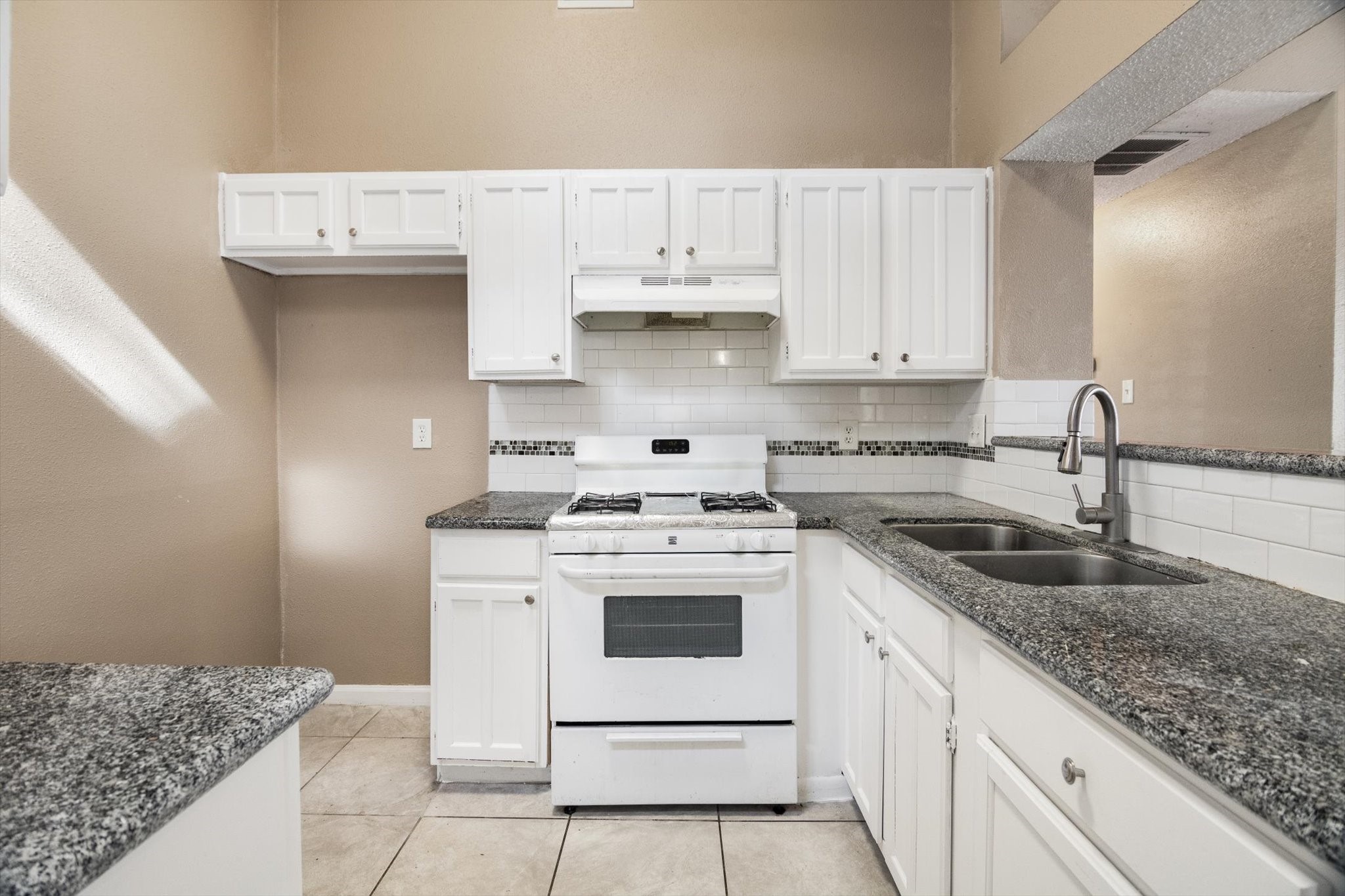 4403 Conward Drive Houston, TX 77066 - Photo 12 of 25 a kitchen with granite countertop white cabinets and white appliances